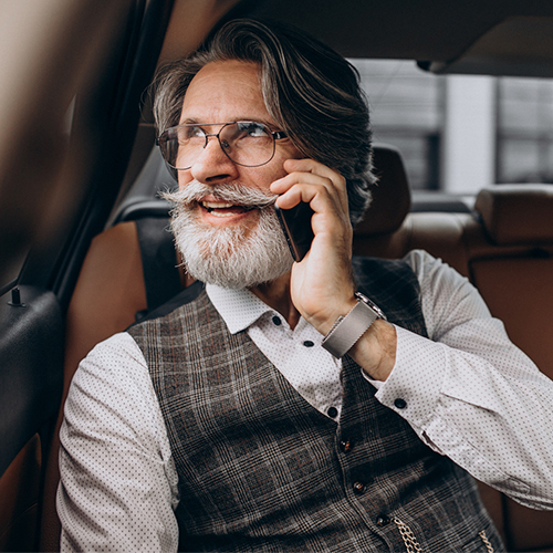 Businessman inside a car holding a cellphone. Atlanta Short Term Rentals for Owner Management.